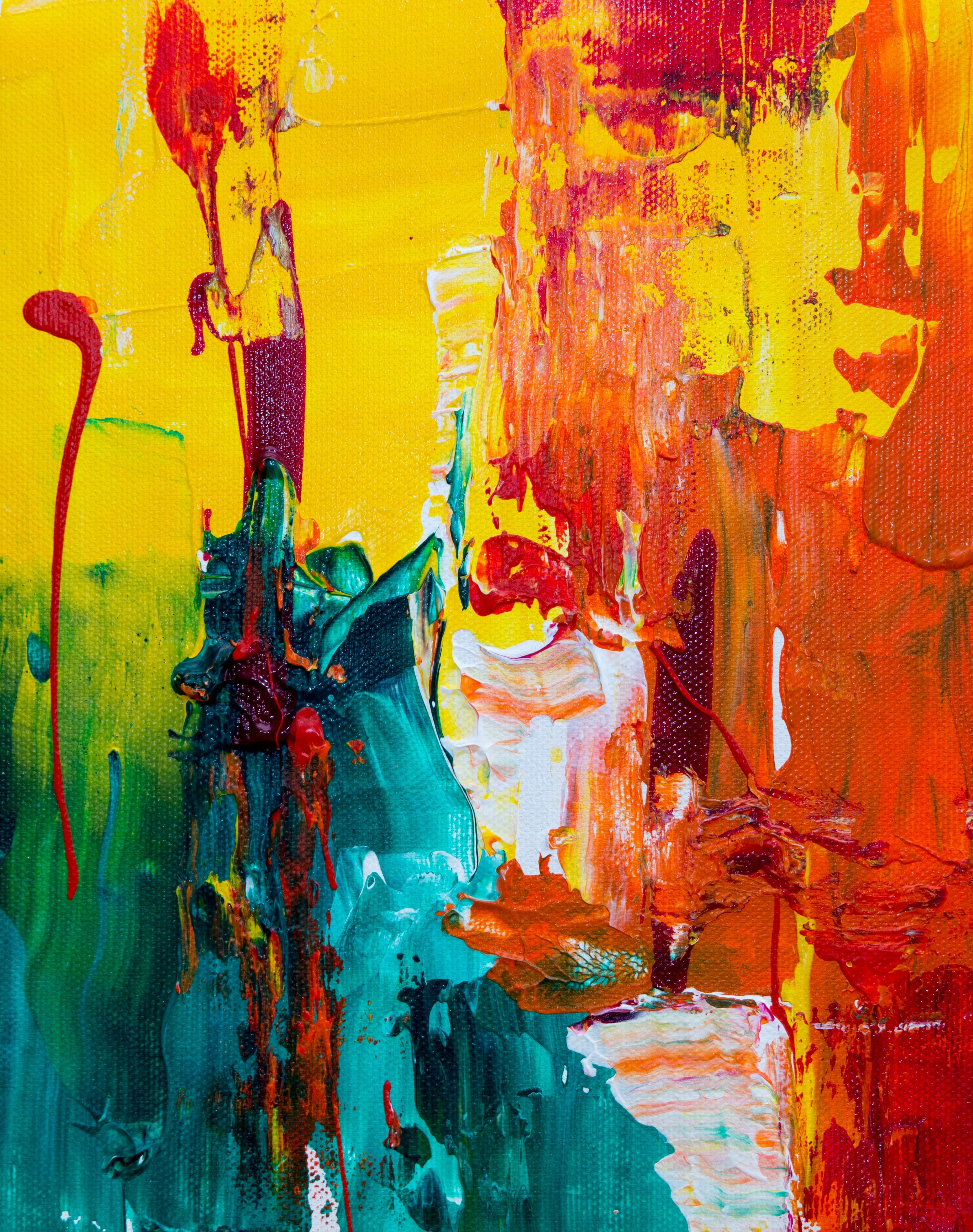 A vivid abstract painting of overlapping red, blue and yellow strokes