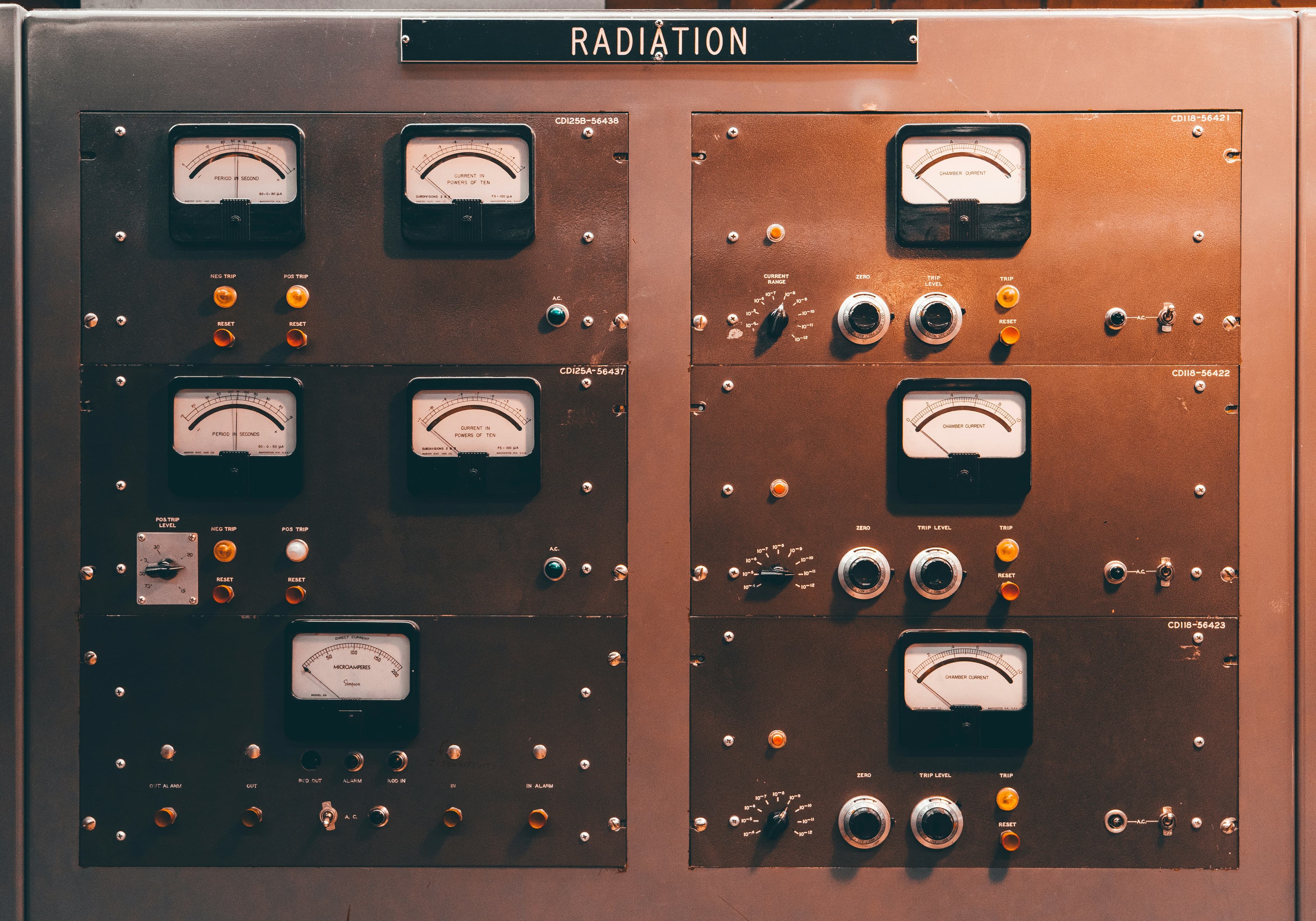 Close-up of a control panel with rows of dials and gauges