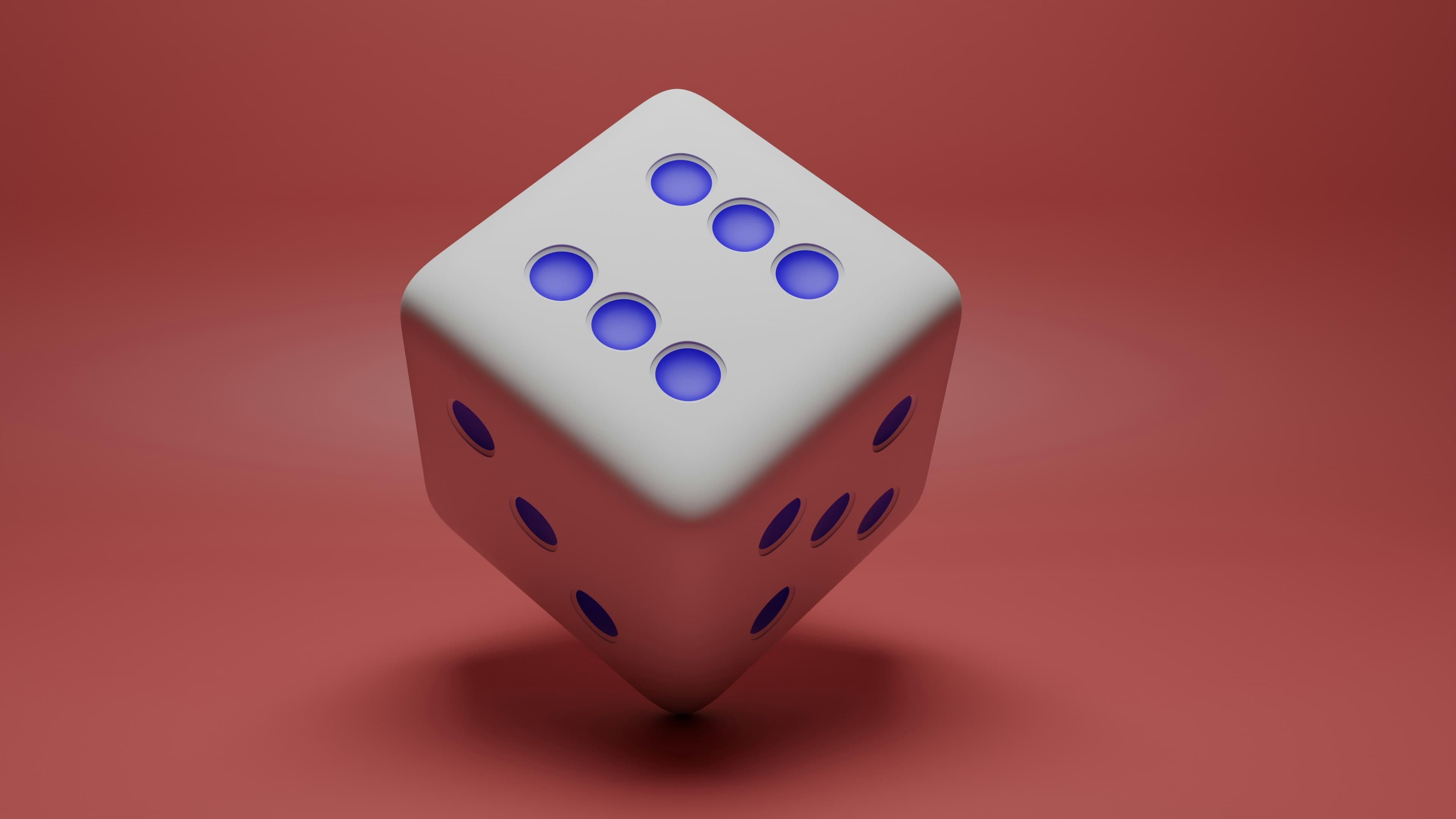 Close-up of a single die on a dark surface